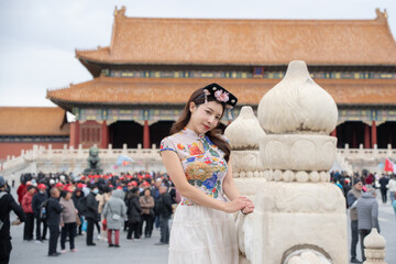 Woman with Traditional Contemporary Chinese costume and headband in Forbidden City in Beijing,...