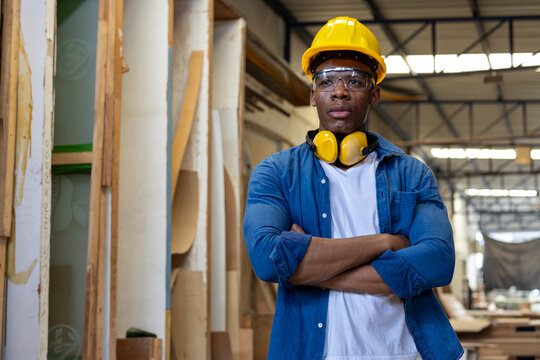 young african american male carpenter worker hold wooden plank at the carpentry workshop