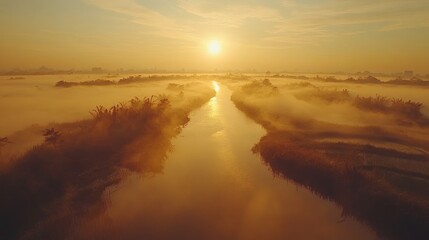 Golden sunrise over a misty river