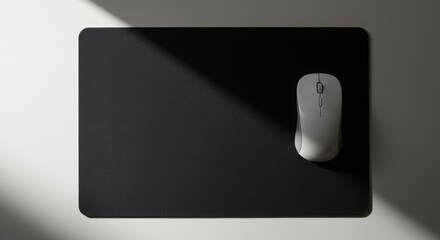 A minimalist and modern mousepad and mouse with a slanted light with an unusual yet beautiful camera angle,