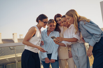 A group of friends enjoying a delightful moment together on a rooftop setting in the city