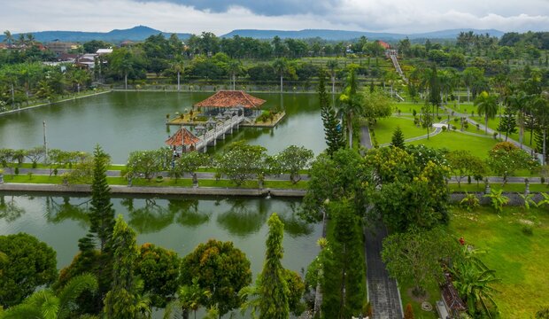 Aerial view of Taman Ujung Water Palace, a former royal palace, now a tourist attraction, featuring ponds, gardens, and ornate structures in  Ujung, Bali, Indonesia