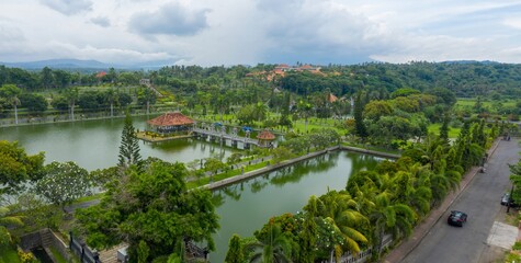 Fototapeta premium Aerial view of Taman Ujung Water Palace, a former royal palace, now a tourist attraction, featuring ponds, gardens, and ornate structures in Ujung, Bali, Indonesia