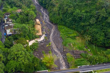 An aerial view shows the aftermath of a lahar flow in Tembuku, Bali, Indonesia. The river of mud...
