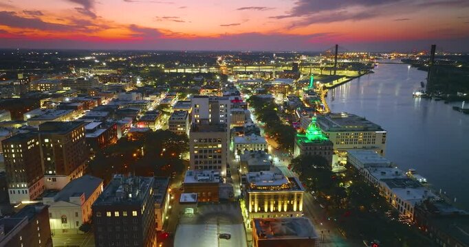 Historical American city architecture at night. Savannah, old city in Georgia state. Illuminated streets and buildings from above.