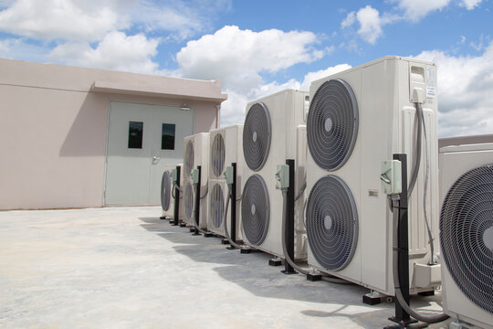 Air conditioning outdoor unit compressor install outside the building. - Powered by Adobe