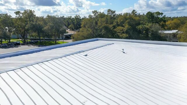 White roof coating protecting commercial building from sunlight
