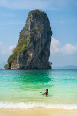 summer asian child swim in clear blue sea on beach alone or kid girl tourist wear swimming diving goggles to playing nature water at ko poda island in krabi thailand for people holiday vacation travel