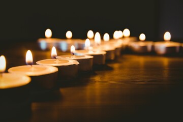 Candles in shape of cross on table