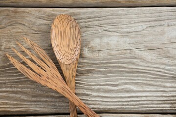 Wooden spoon and fork on table © vectorfusionart