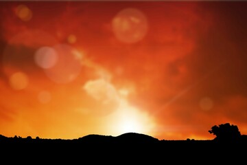 Obraz premium Flat design is showing sunset sky with sun emerging above dark hills, lens flares and trees