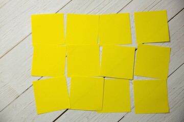 Yellow papers on wooden surface