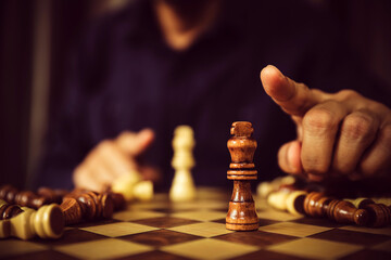 King chess on falling chess concept of business strategy plan and leadership or wining challenge and team player and risk management or human resource or strategic planning.