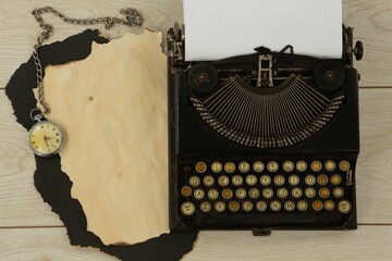 Paper piece, typewriter and clock on table