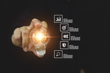 Hand chooses light bulb with business plan icons for human resources goal and creative idea innovation or study education or analyzing marketing data management and target growth.
