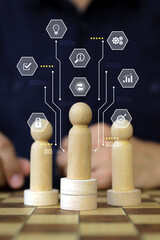 Hand chooses person wooden doll with HR human resources icons for leader of group teamwork officer or business planning relationship or team player and personnel management job performance.