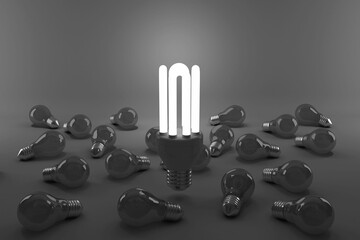 Digital composite image of illuminated energy efficient lightbulb over bulbs