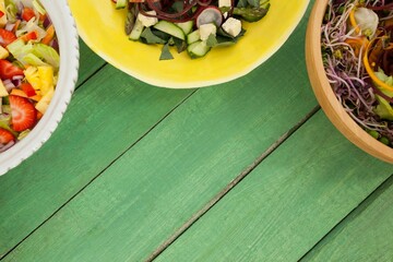 Cropped image of food in bowls on green table