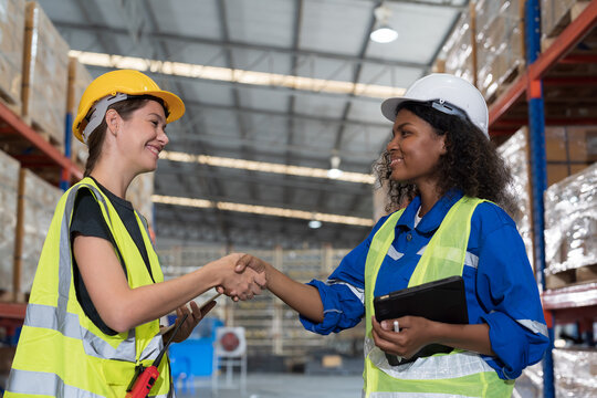 Group of warehouse worker join hands together, meeting, Work completed successfully. Collaboration colleagues, teamwork and unity in warehouse