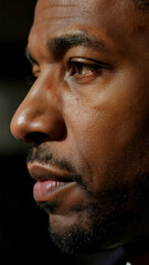 Obraz premium Close-Up Profile of a Thoughtful Black Man in Studio Lighting
