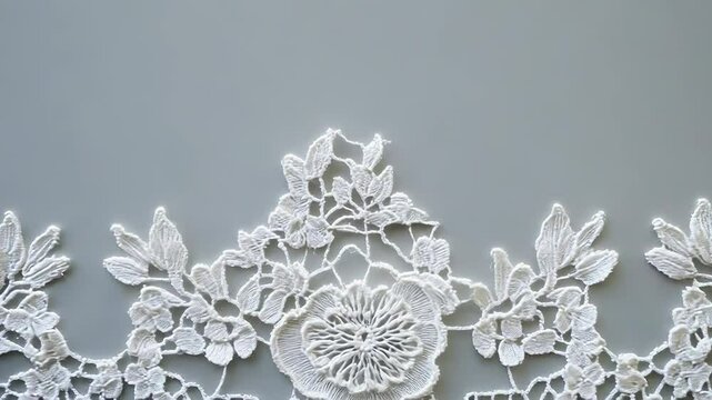 White lace floral border creating elegant frame on gray background