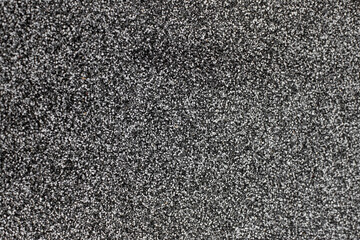 Crushed black and white stone stucco, decorative facade texture, close up , abstract backdrop