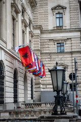 Albanian flag hanging first among many flags of various countries on a building in the city of Vienna.