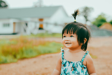 Family life cute baby girl smiling a lush garden captured an asian setting