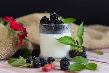 Summer dessert of yogurt with berries and flowers