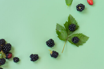 Natural summer berries with shine and details on a green background