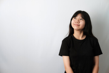 Cute Asian girl in black t-shirt, Looking Up and Slightly Smiling