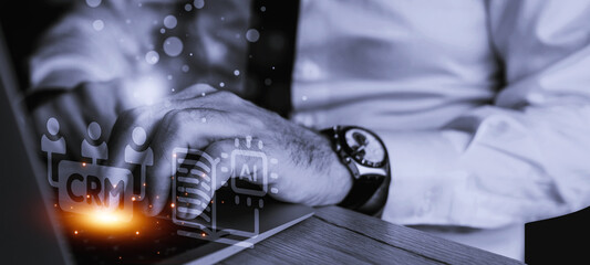 An executive hand engaging a CRM system on a digital device, symbolizing modern business technology and data-driven decision-making.