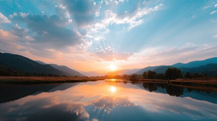 Fototapeta premium Serene Sunrise Over Tranquil Lake Surrounded by Mountains and Colorful Sky Reflected in Calm Water
