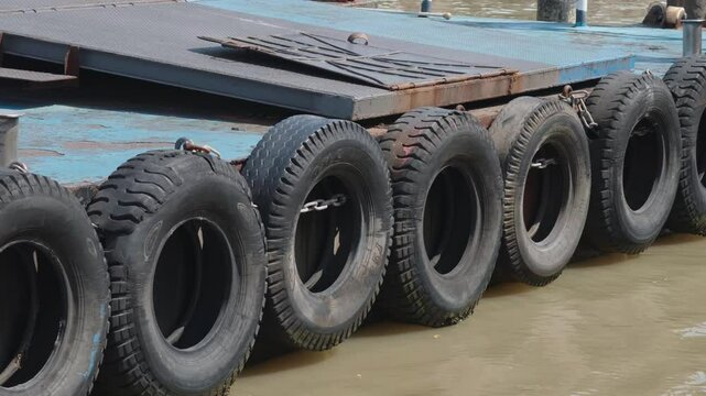 The hanging tires act as shock absorbers and fenders for the boat.