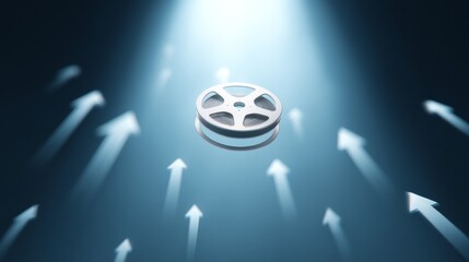 A metallic film reel is highlighted by a spotlight, surrounded by upward-pointing arrows, symbolizing focus, direction, or progress in film or media.