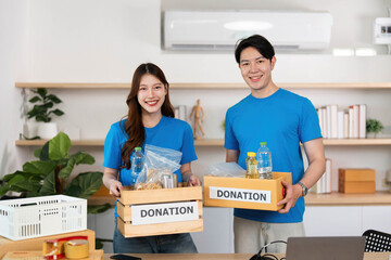 Donation Efforts. Volunteers proudly holding donation boxes filled with items.