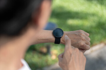 Smartwatch Technology. Close-up of user interacting with smartwatch outdoors.