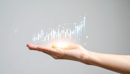 Fototapeta premium A line graph showing real-time stock price trends floating above a hand on a blurred grey background