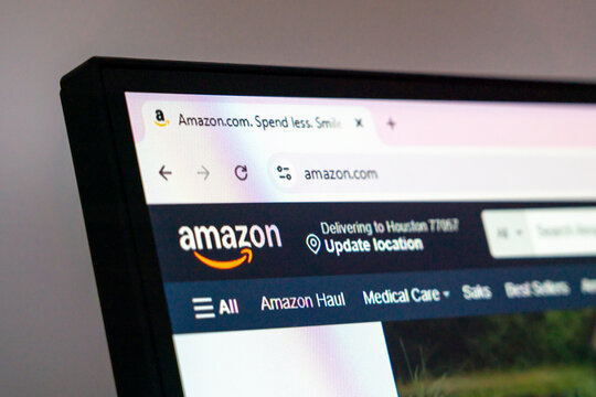 Houston, USA - July 7, 2025: Amazon e-commerce and delivery website with logo and location banner visible on computer screen in web browser