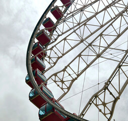 Closeup of a colorful ferris wheel on a white background