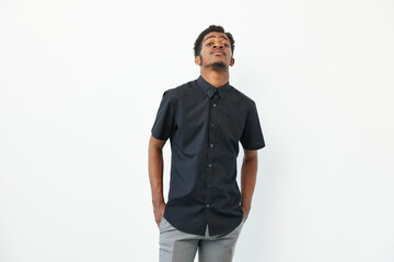 Black man wearing a stylish black shirt with confidence, expressing a thoughtful mood against a...