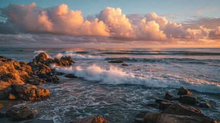 Obraz premium A stunning sunset over the ocean, highlighting waves crashing against rocky shores under a colorful sky.