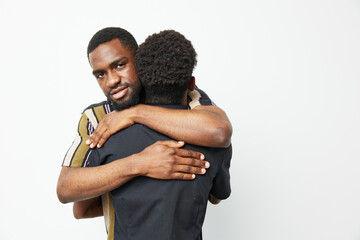 Two black men sharing a warm embrace, expressing friendship and solidarity. The image features a...