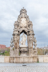 Obraz premium Madrid, Spain - march 30, 2025: Recently restored medieval sculpture on the Toledo Bridge in Madrid depicting the figure of Santa Maria de la Cabeza