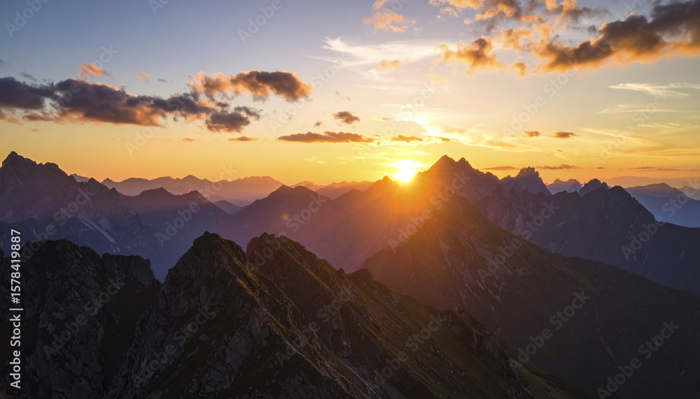 Poster sunset over mountain range with glowing sky and scattered clouds creating warm mood