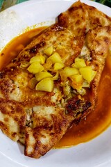Crispy Stuffed Flatbread with Curry. 
A golden crispy flatbread filled with savory meat and...