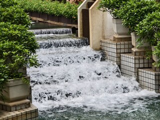 A beautiful fountain in the park is elegantly surrounded by stairs