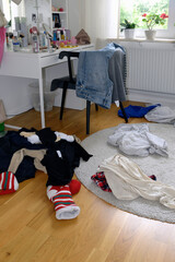Showing mess in a teenage girls bedroom