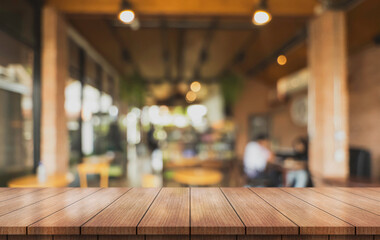Empty wooden table top with lights bokeh on blur restaurant background.	