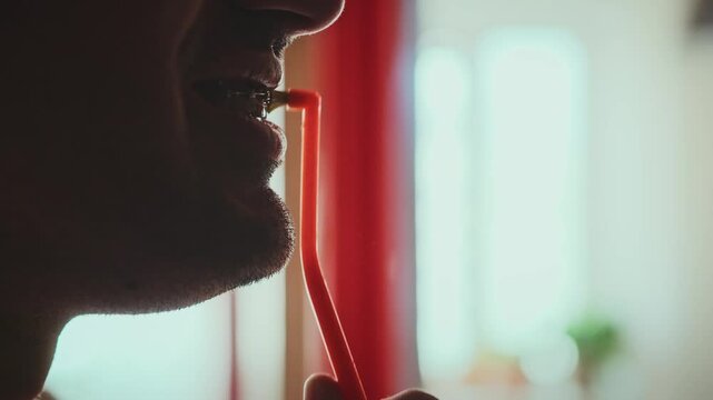 Cleaning metal braces with a toothbrush in longitudinal movements, shot close-up